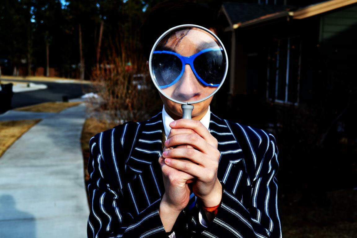 Sales recruiter looking with binoculars to find sales talent